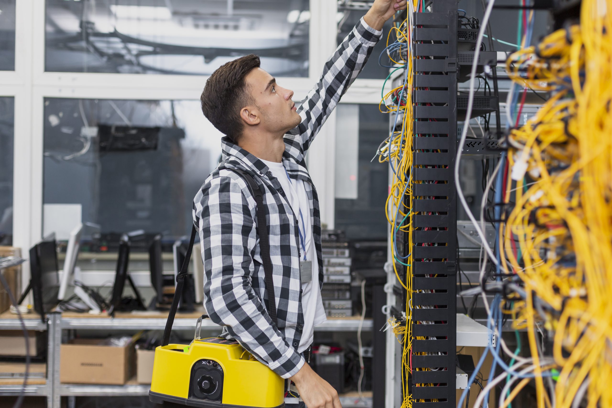 young-network-engineer-with-box-looking-ethernet-switches